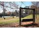 Park swing set in a grassy area with a tennis court and playground in the background at 388 Londonberry Road, Sandy Springs, GA 30327