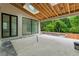 Expansive covered patio with skylights, overlooking lush greenery, and featuring an outdoor kitchen at 388 Londonberry Road, Sandy Springs, GA 30327