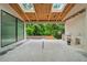 Large, covered patio with beautiful backyard views, skylights, and an outdoor kitchen under construction at 388 Londonberry Road, Sandy Springs, GA 30327