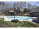 Large swimming pool with multiple lanes, surrounded by a grassy area and trees at 388 Londonberry Road, Sandy Springs, GA 30327