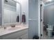 A cozy bathroom featuring a well-lit vanity, a neutral gray color palette, and access to the toilet area at 3220 Millwood Se Trl, Smyrna, GA 30080