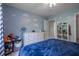 Bright bedroom featuring playful cloud wall decorations, a ceiling fan, and ample storage at 3220 Millwood Se Trl, Smyrna, GA 30080