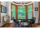 Bright breakfast nook with hardwood floors, wood trim windows, and table with seating for four at 3220 Millwood Se Trl, Smyrna, GA 30080