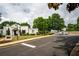 Street view showcasing the white brick clubhouse with parking and mature trees at 3220 Millwood Se Trl, Smyrna, GA 30080