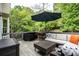 Relaxing deck space featuring outdoor furniture, grill, and view of the tree-lined backyard at 3220 Millwood Se Trl, Smyrna, GA 30080