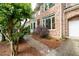Beautiful brick home with a well-manicured lawn and a brick walkway to the front door at 3220 Millwood Se Trl, Smyrna, GA 30080