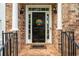 Inviting front entrance with a black door, white columns, and decorative welcome sign at 3220 Millwood Se Trl, Smyrna, GA 30080
