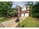 Traditional brick home with manicured lawn and an inviting driveway leading to a two-car garage at 3220 Millwood Se Trl, Smyrna, GA 30080
