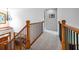 Spacious hallway with hardwood railing and black iron spindles that provides access to the upper level rooms at 3220 Millwood Se Trl, Smyrna, GA 30080