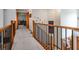 Hallway featuring a decorative banister, light neutral paint colors, and beautiful interior design features at 3220 Millwood Se Trl, Smyrna, GA 30080