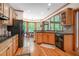 Bright kitchen with wood cabinets, granite counters, stainless appliances, and views to a bay window breakfast nook at 3220 Millwood Se Trl, Smyrna, GA 30080