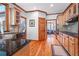 Spacious kitchen featuring wood floors, light wood cabinets, granite countertops, and access to other rooms in the house at 3220 Millwood Se Trl, Smyrna, GA 30080