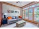 Cozy living room with ample natural light, a comfortable sofa, and custom built-ins at 3220 Millwood Se Trl, Smyrna, GA 30080