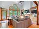 Bright living room featuring hardwood floors, built-in shelves, a fireplace, and backyard views at 3220 Millwood Se Trl, Smyrna, GA 30080