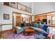 Open-concept living room with hardwood floors, tall ceilings, an upstairs balcony, and access to the kitchen at 3220 Millwood Se Trl, Smyrna, GA 30080