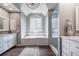 Beautiful bathroom featuring a soaking tub, glass-enclosed shower, and dual vanity sinks with marble countertops at 3220 Millwood Se Trl, Smyrna, GA 30080