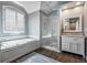 Beautiful bathroom featuring a soaking tub, glass-enclosed shower, and dual vanity sinks with marble countertops at 3220 Millwood Se Trl, Smyrna, GA 30080