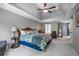 Serene main bedroom features a tray ceiling and a large window that offers natural lighting at 3220 Millwood Se Trl, Smyrna, GA 30080