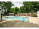 Relaxing community pool area with lounge chairs, pergola, and well-maintained concrete decking at 3220 Millwood Se Trl, Smyrna, GA 30080