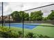 Fenced tennis court with blue playing surface offering recreational opportunity at 3220 Millwood Se Trl, Smyrna, GA 30080