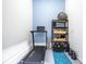 Workout area with a treadmill, shelving, and a yoga mat on the painted concrete flooring at 3220 Millwood Se Trl, Smyrna, GA 30080
