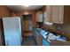 Dilapidated kitchen featuring white refrigerator, laminate counters, and stained tile floors at 45 James P Brawley Nw Dr, Atlanta, GA 30314
