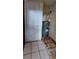 Utility room showcasing water heater, and door with stained tiled floors at 45 James P Brawley Nw Dr, Atlanta, GA 30314