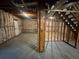 Unfinished basement with exposed beams and studs offering a view of the staircase at 4911 Hairston Pl, Stone Mountain, GA 30088