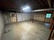 Unfinished basement offering a blank canvas with existing garage and window at 4911 Hairston Pl, Stone Mountain, GA 30088