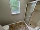This bathroom has tile floors, a standing shower, and a window to let in natural light at 4911 Hairston Pl, Stone Mountain, GA 30088