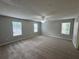 Spacious bedroom features neutral paint, a ceiling fan, and large windows for natural light at 4911 Hairston Pl, Stone Mountain, GA 30088