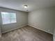 This bedroom has neutral carpet and one window to let in natural light at 4911 Hairston Pl, Stone Mountain, GA 30088