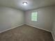 This bedroom has neutral carpet and one window to let in natural light at 4911 Hairston Pl, Stone Mountain, GA 30088
