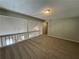 Bonus room area with view overlooking the floor below and a closet door on the right at 4911 Hairston Pl, Stone Mountain, GA 30088