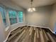 Dining room with natural light, updated flooring, and contemporary lighting at 4911 Hairston Pl, Stone Mountain, GA 30088