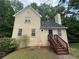 Charming exterior view of home, featuring a unique design, inviting front entry, and mature landscaping at 4911 Hairston Pl, Stone Mountain, GA 30088