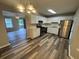 Well-lit kitchen featuring stainless steel appliances, white cabinetry, and modern flooring at 4911 Hairston Pl, Stone Mountain, GA 30088