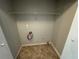 A cozy laundry room offers a place to get tasks done with available shelving space at 4911 Hairston Pl, Stone Mountain, GA 30088