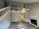 Bright living room boasts vaulted ceilings, fireplace, modern flooring, and open concept floor plan at 4911 Hairston Pl, Stone Mountain, GA 30088