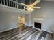 Bright living room boasts vaulted ceilings, fireplace, modern flooring, and open concept floor plan at 4911 Hairston Pl, Stone Mountain, GA 30088