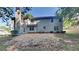 View of the home's backyard with a two-story home and light gray vinyl siding at 5368 Knights Lndg, Ellenwood, GA 30294
