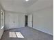 Bright bedroom featuring neutral carpet, a vaulted ceiling, and double doors for a cozy retreat at 5368 Knights Lndg, Ellenwood, GA 30294