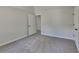 Neutral carpeted bedroom with closet and access to other areas of the home at 5368 Knights Lndg, Ellenwood, GA 30294