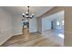 Bright dining area featuring wood-look flooring and a modern chandelier, creating an inviting space at 5368 Knights Lndg, Ellenwood, GA 30294