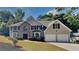 Charming two-story home with a stone accent, attached two-car garage, and a well-maintained lawn at 5368 Knights Lndg, Ellenwood, GA 30294