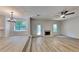 Open living space showcasing wood-look floors, a fireplace, and a ceiling fan for a comfortable living area at 5368 Knights Lndg, Ellenwood, GA 30294