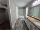 Bright bathroom featuring granite countertops, double sinks, white cabinets, and a shower-over-tub at 675 Stonebridge Loop, Lithonia, GA 30058
