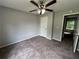 Bedroom featuring neutral walls, ceiling fan, carpet flooring, and two entry doors at 675 Stonebridge Loop, Lithonia, GA 30058