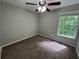 Bedroom featuring neutral walls, carpet flooring, ceiling fan, and natural lighting at 675 Stonebridge Loop, Lithonia, GA 30058