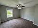 Bedroom featuring neutral walls, ceiling fan, carpet flooring, and natural light at 675 Stonebridge Loop, Lithonia, GA 30058